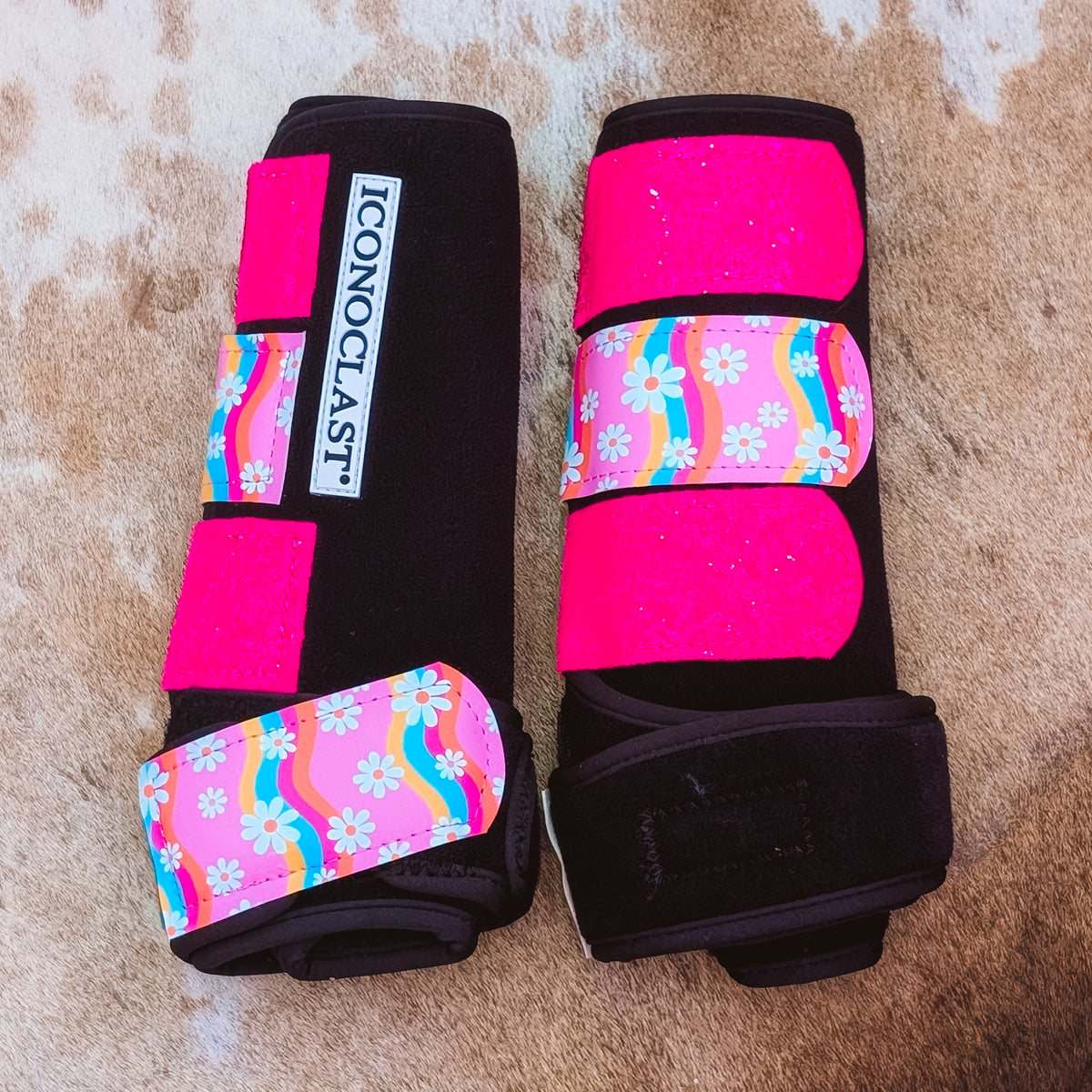 Large black Iconoclast front boots with hot pink glitter straps and rainbow daisy print straps