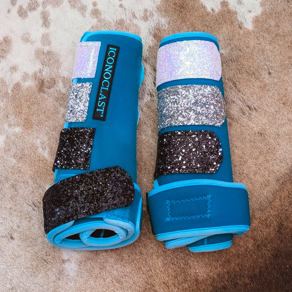 Medium teal dyed Iconoclast front boots with white to silver to black ombre glitter straps