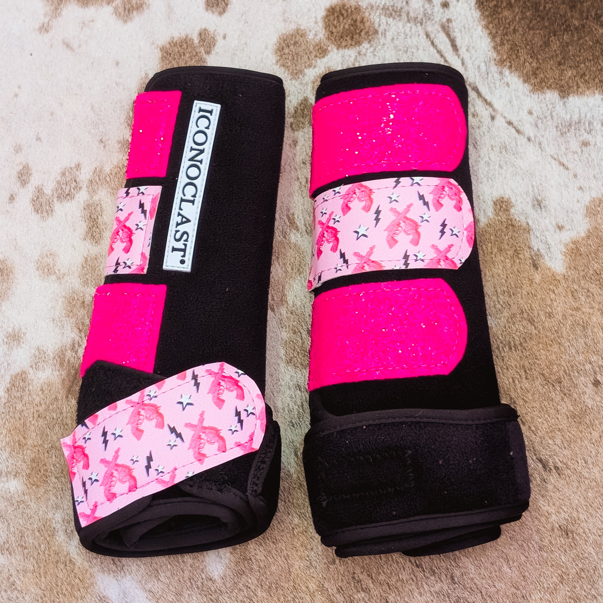 Large black Iconoclast front boots with hot pink glitter straps and Loaded With Attitude pistol print straps